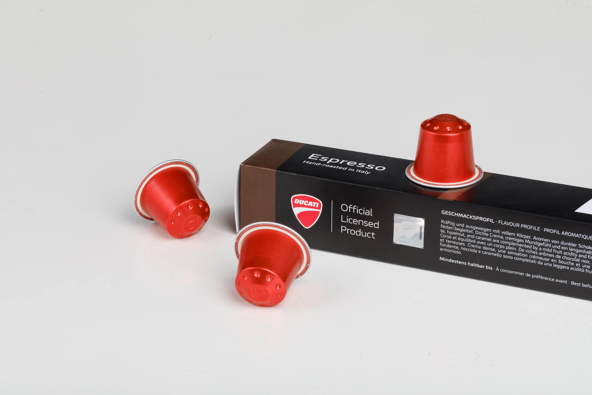 Espresso by Ducati box close-up, Official Licensed Product, with red Nespresso® Original compatible capsules